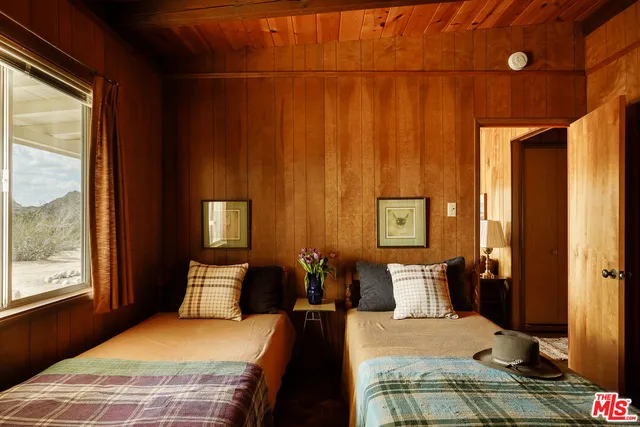 a bedroom with a bed and a mirror