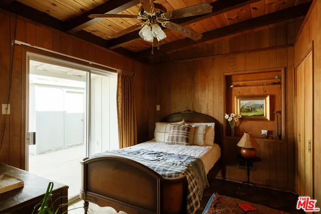 a bed sitting in a bedroom next to a lamp