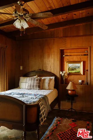 a living room with furniture a rug and white walls