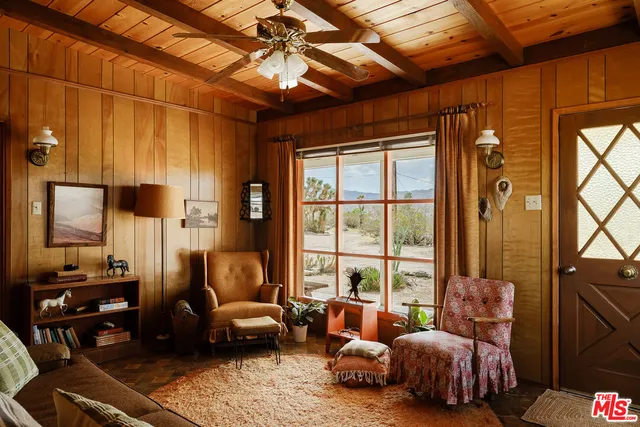 a bedroom with furniture and a large window