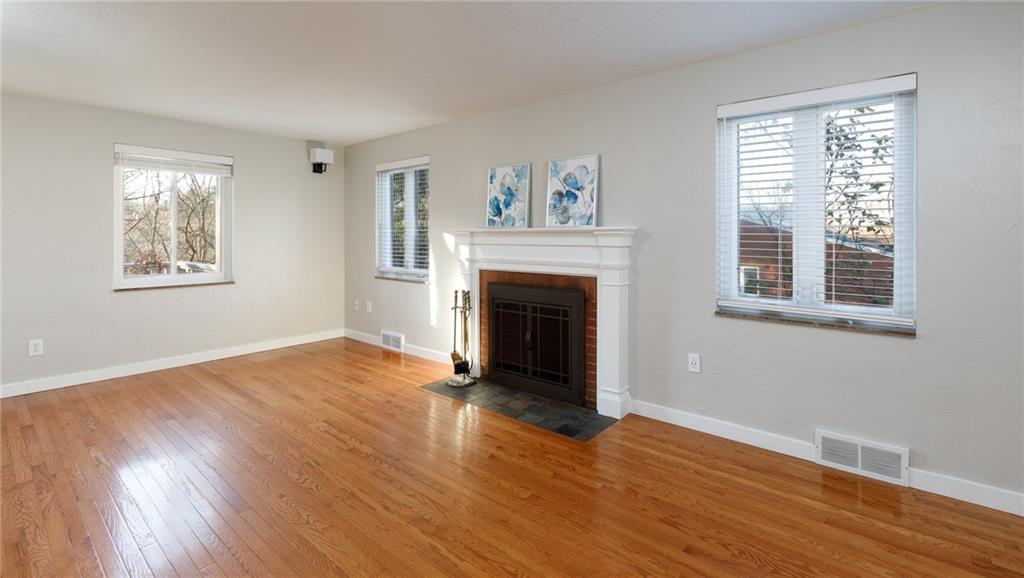 9347 Pannier Road Pittsburgh, PA 15237 - Photo 4 of 25 Hardwood floors in the living room with wood-burning fireplace.