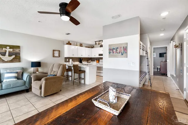 a living room with furniture and kitchen view