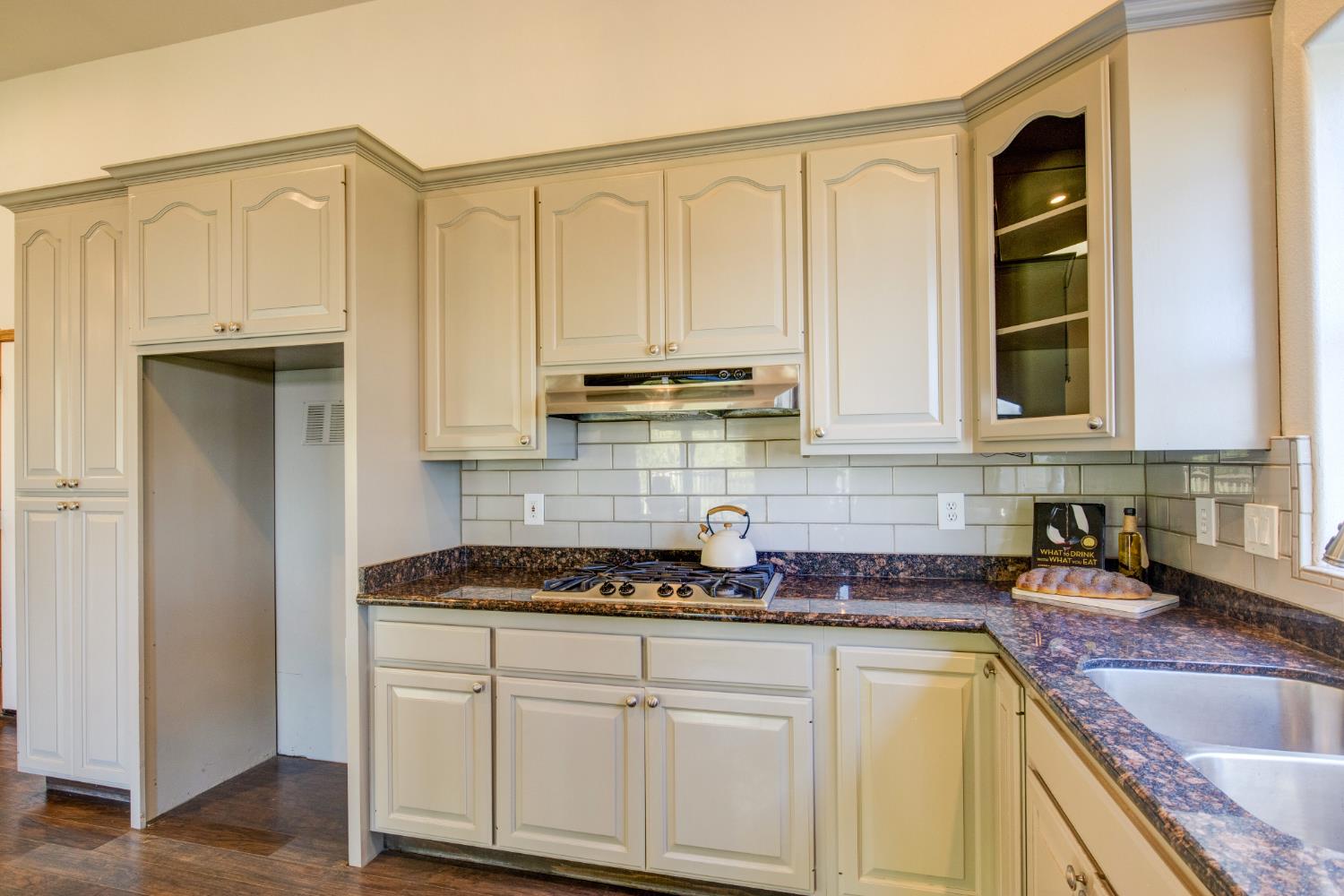 3900 Tawanka Road Somerset, CA 95684 - Photo 14 of 84 a kitchen with stainless steel appliances granite countertop a sink a stove and cabinets