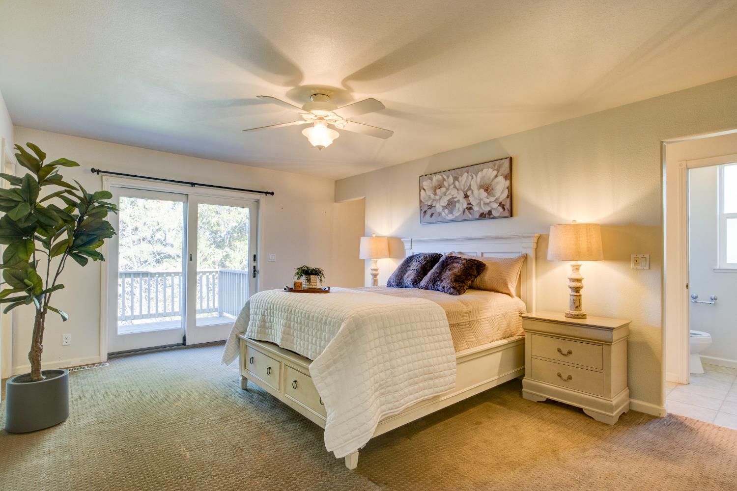 3900 Tawanka Road Somerset, CA 95684 - Photo 17 of 84 a spacious bedroom with a large bed and a chandelier