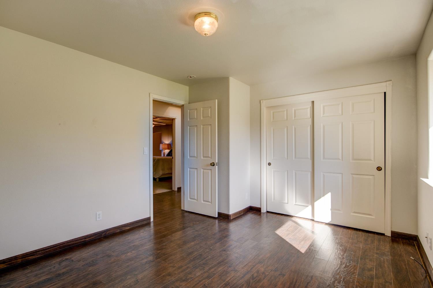 3900 Tawanka Road Somerset, CA 95684 - Photo 27 of 84 a view of an empty room with wooden floor and closet