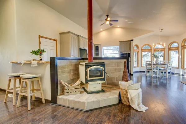 a dining room with furniture a chandelier and wooden floor