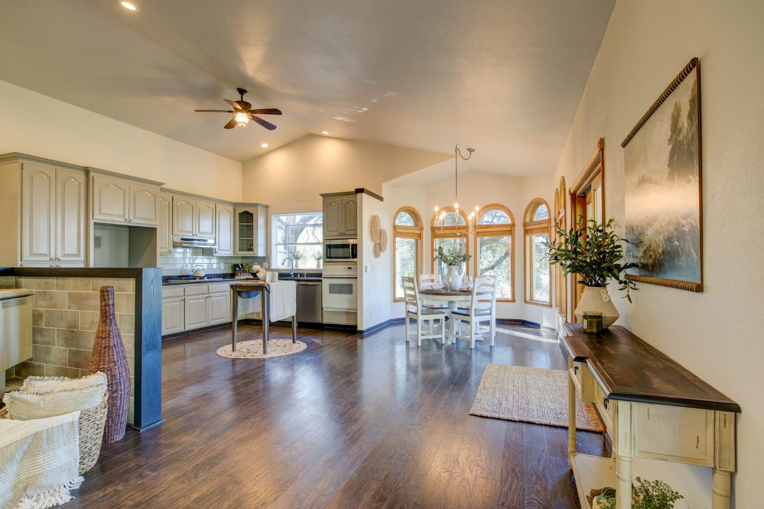 3900 Tawanka Road Somerset, CA 95684 - Photo 8 of 84 a view of a dining room and livingroom with furniture wooden floor a chandelier