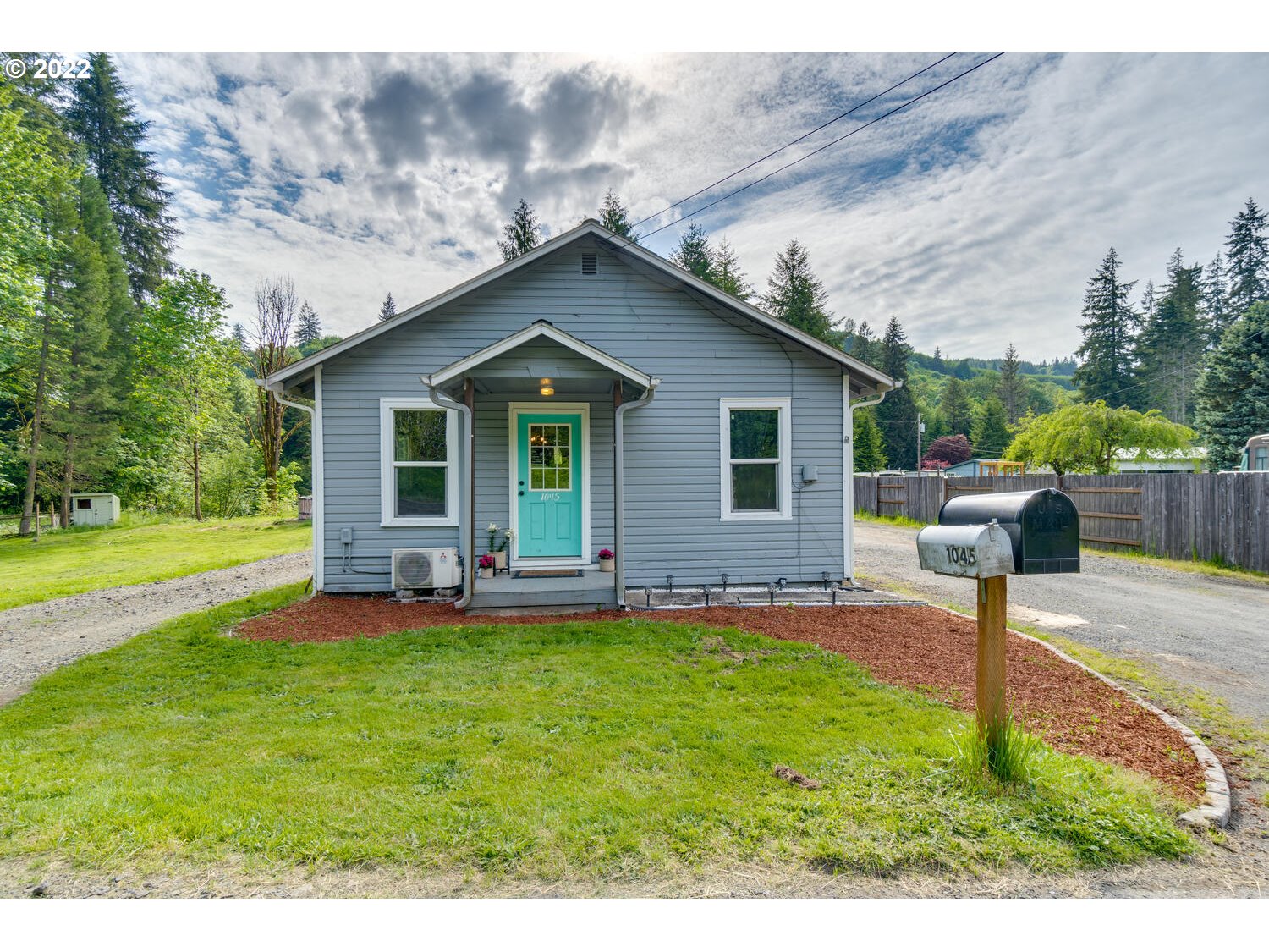 1045 Coal Creek Road Longview, WA 98632 - Photo 1 of 32 a front view of a house with a yard