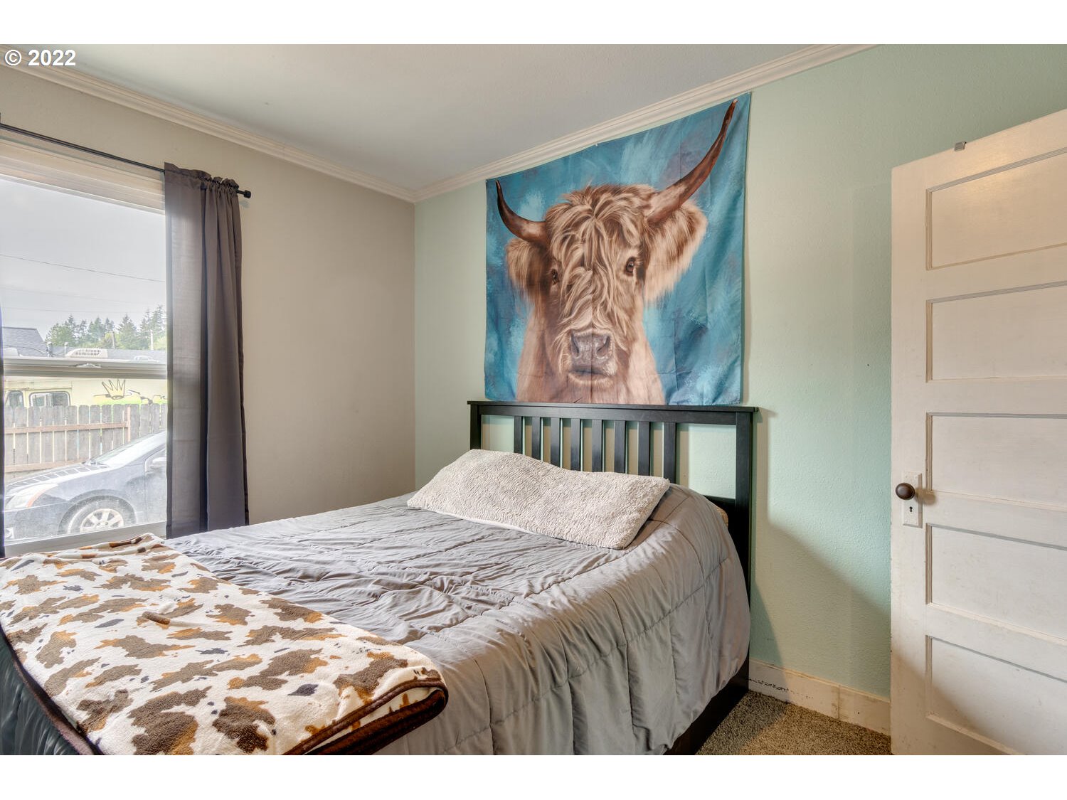1045 Coal Creek Road Longview, WA 98632 - Photo 14 of 32 a bed sitting in a bedroom next to a window