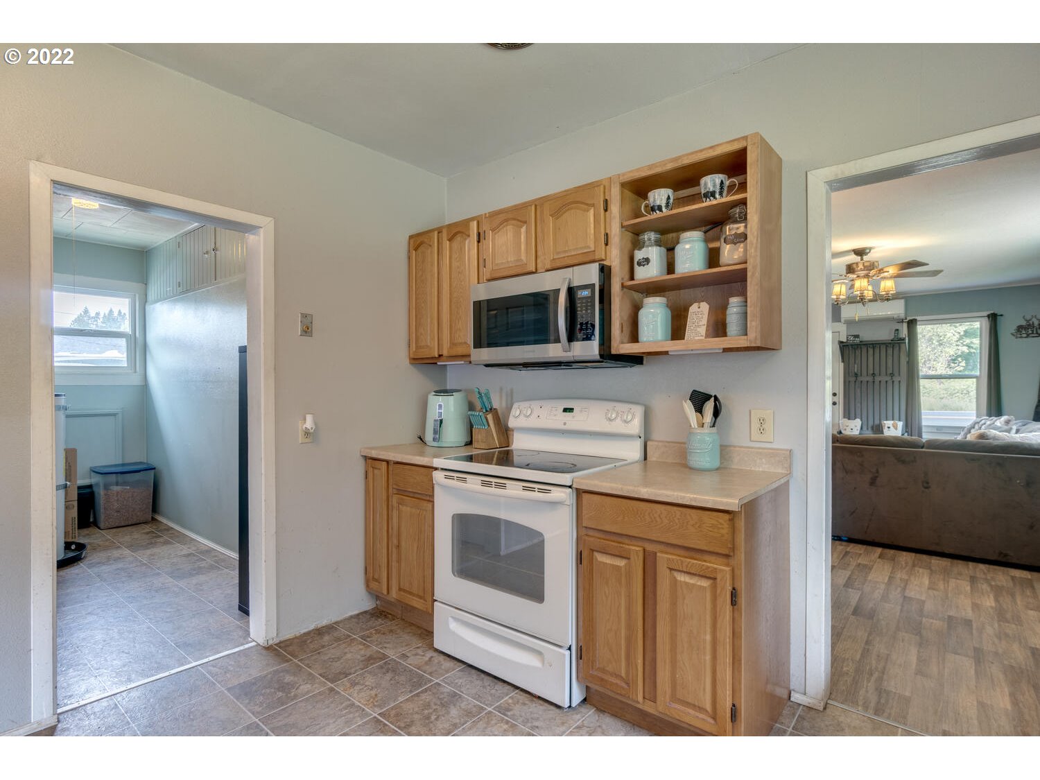 1045 Coal Creek Road Longview, WA 98632 - Photo 22 of 32 a kitchen with stainless steel appliances granite countertop a stove a sink and a microwave