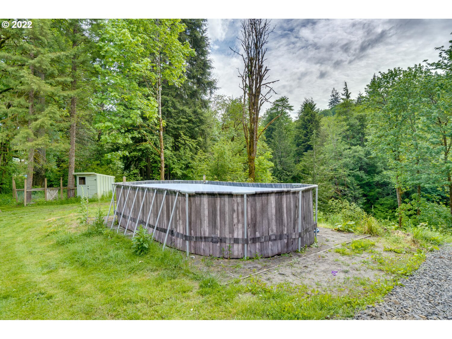 1045 Coal Creek Road Longview, WA 98632 - Photo 29 of 32 a view of a backyard with a small cabin