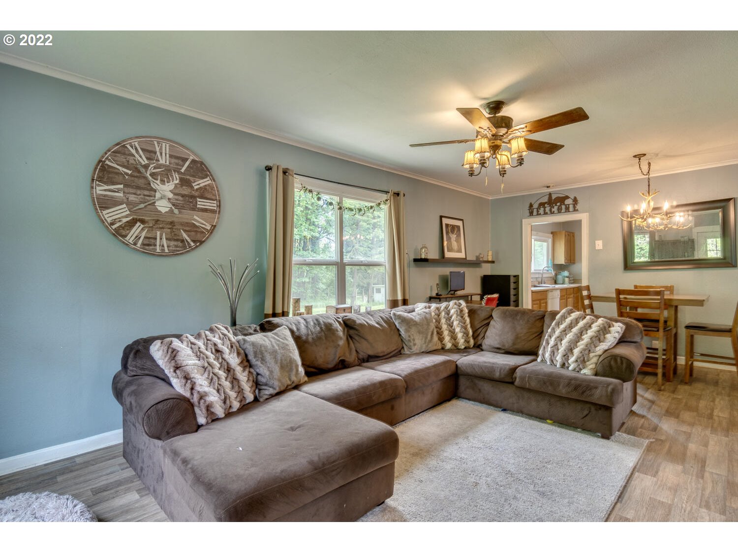 1045 Coal Creek Road Longview, WA 98632 - Photo 6 of 32 a living room with furniture a chandelier and a dining table