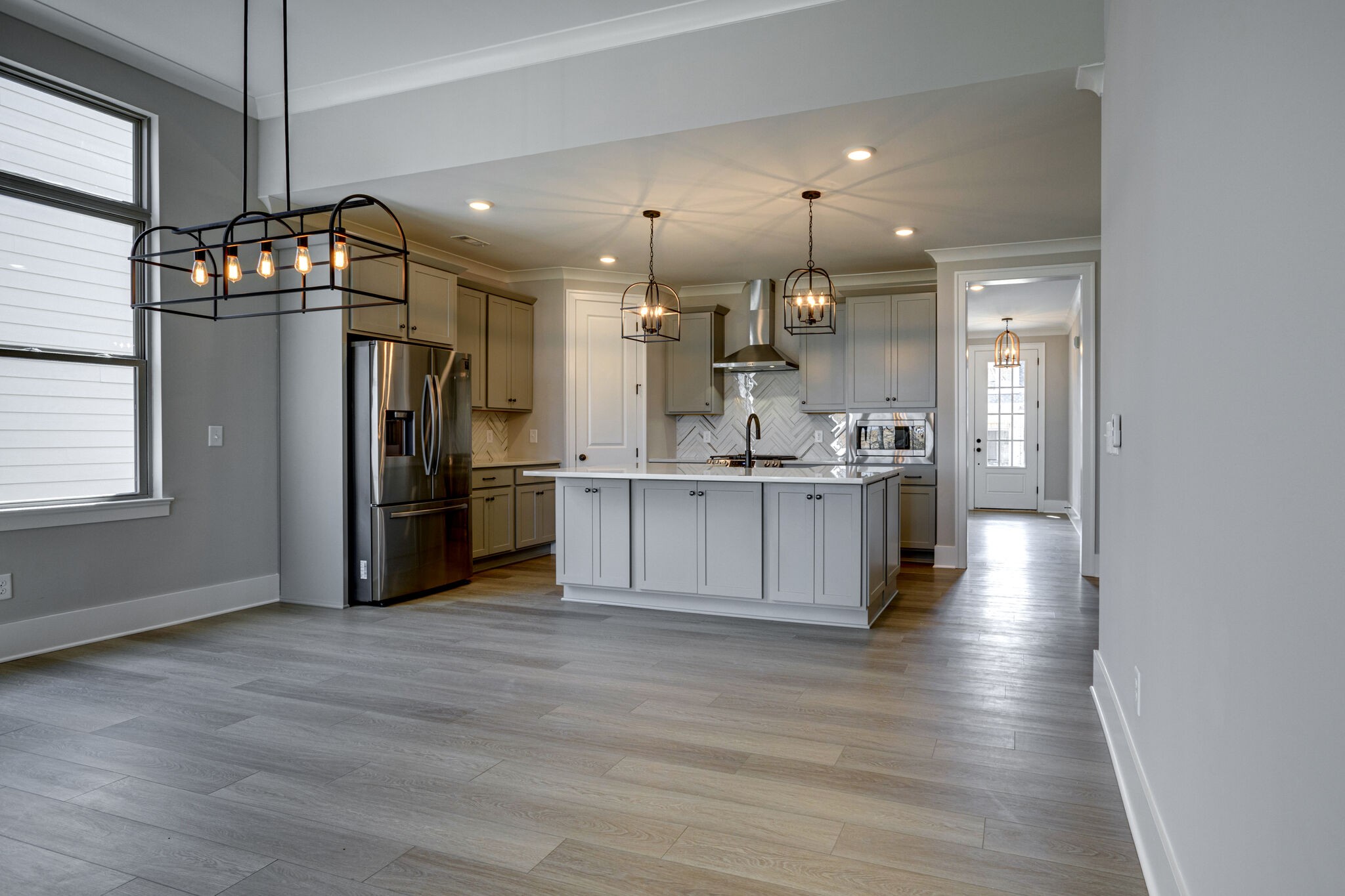 1057 Fallow Road Mount Juliet, TN 37122 - Photo 12 of 41 a kitchen with stainless steel appliances kitchen island granite countertop a refrigerator a oven a stove and a wooden floors
