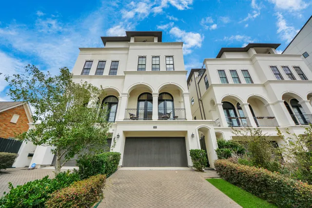a front view of a house with fountain