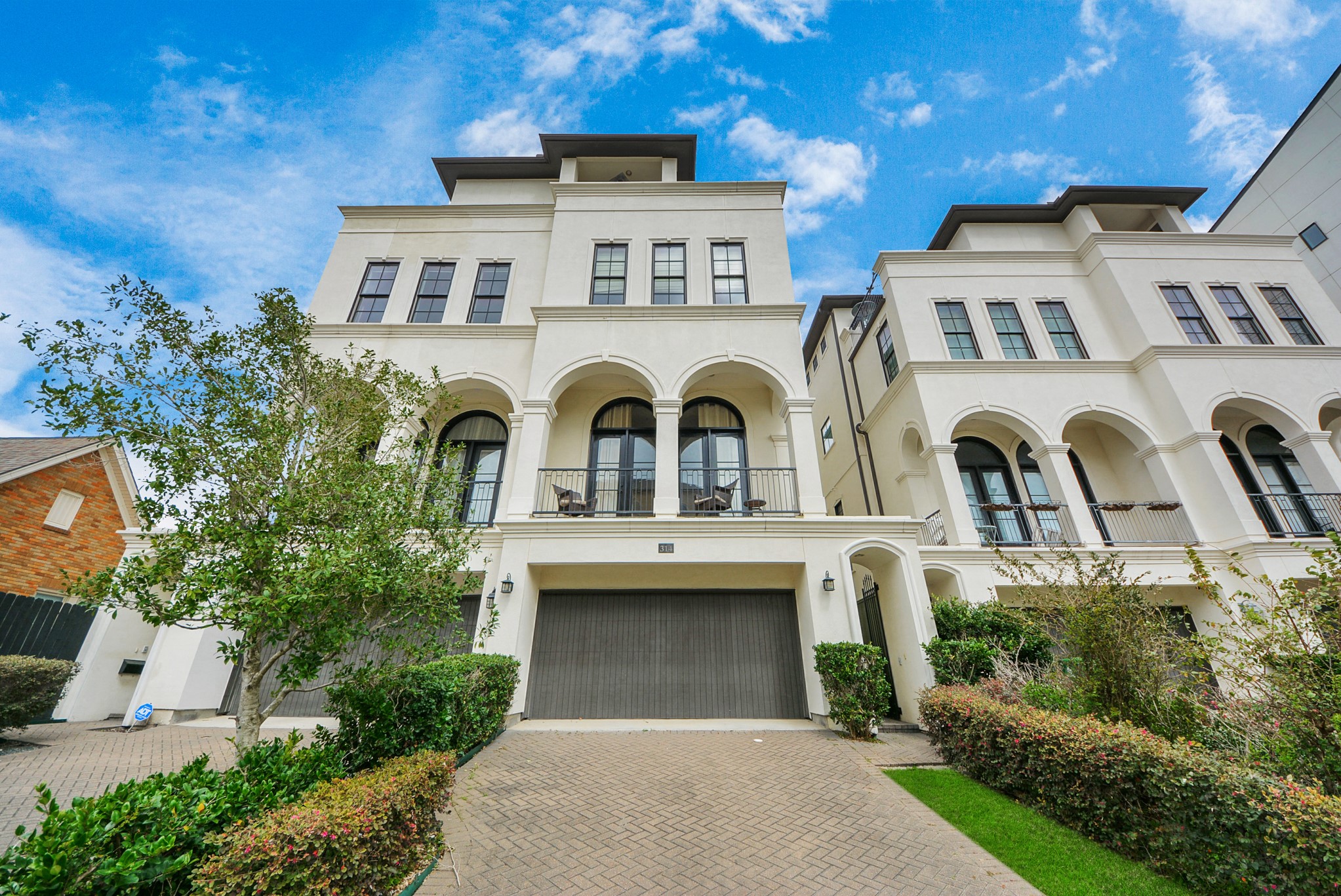 a front view of a house with fountain