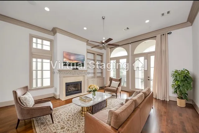 a living room with furniture fireplace and a large window