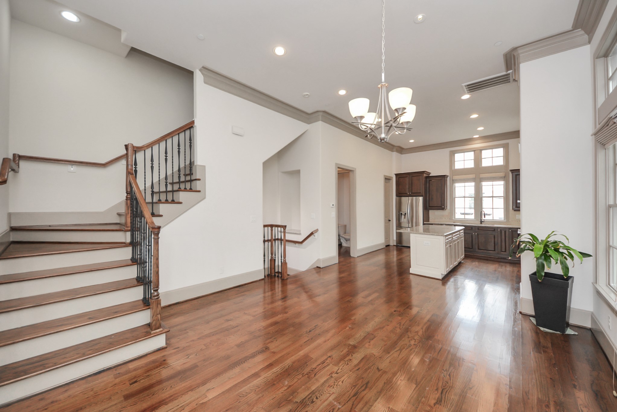 314 West Clay Street Houston, TX 77019 - Photo 15 of 44 a view of a dining room with furniture a chandelier and wooden floor