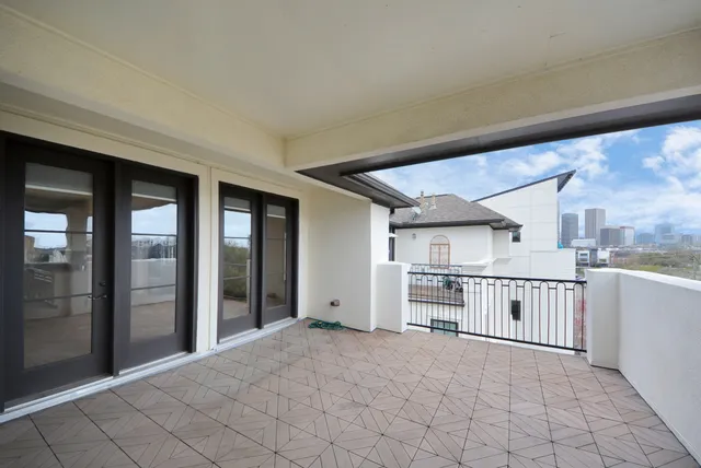 a kitchen with stainless steel appliances granite countertop a refrigerator and white cabinets