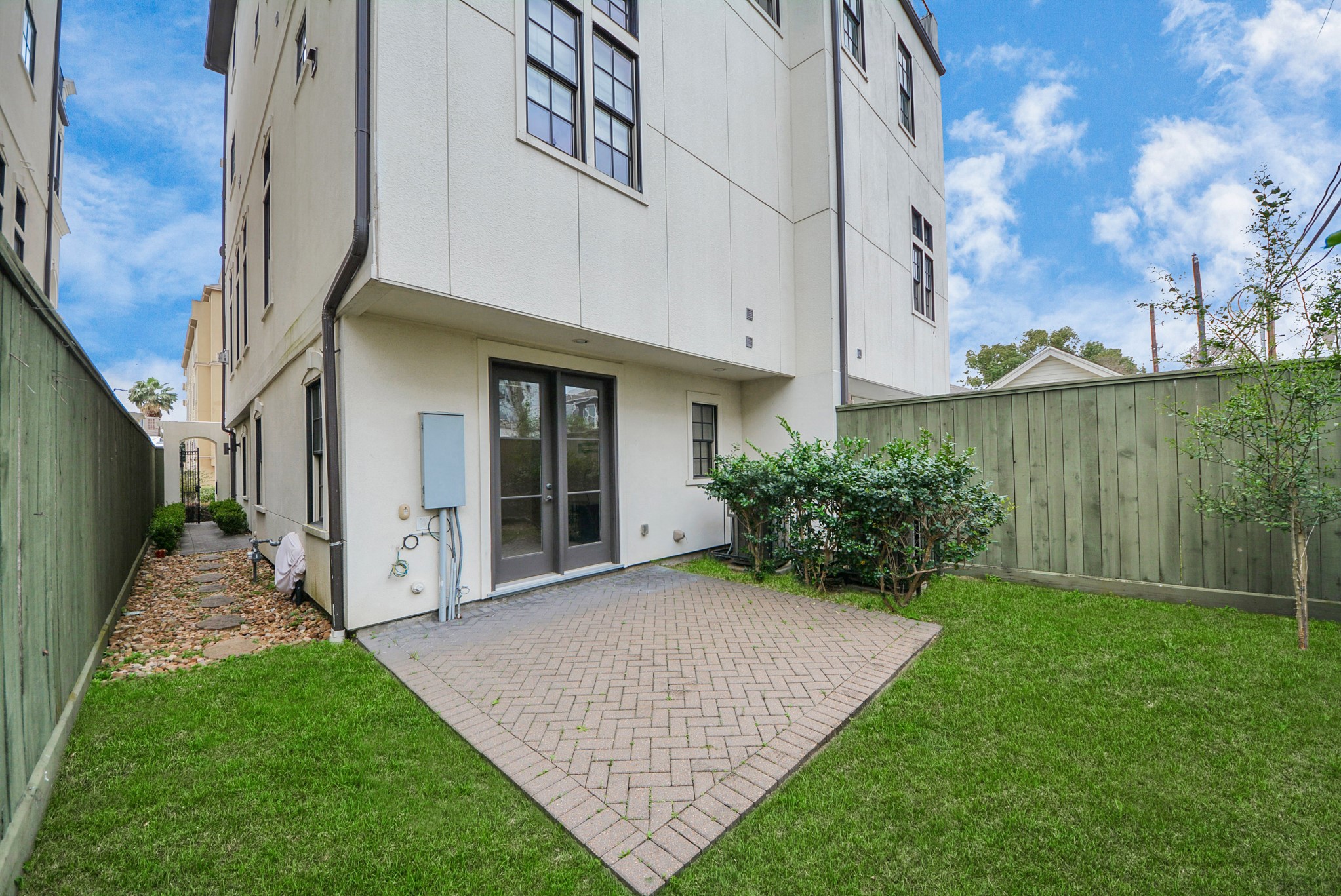 314 West Clay Street Houston, TX 77019 - Photo 43 of 44 a view of a house with brick walls and a yard with plants