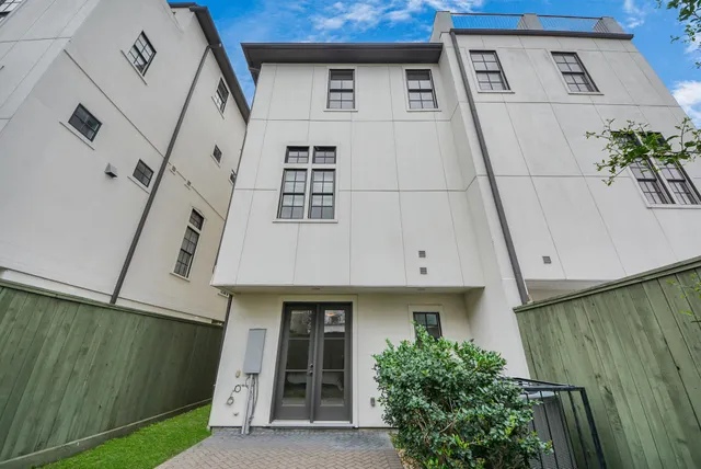 a front view of a house with a plants