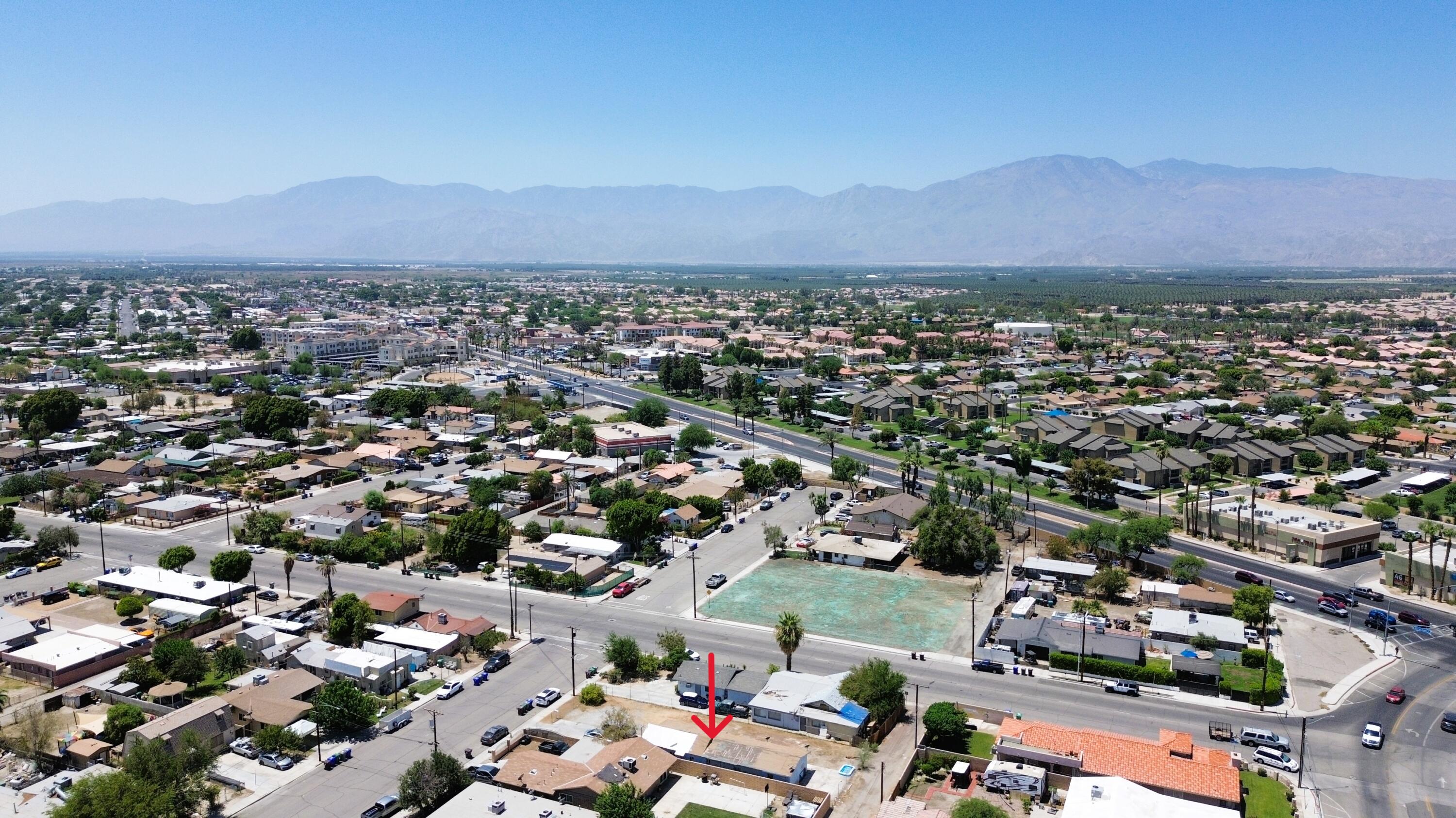 1423 2nd Street Coachella, CA 92236 - Photo 1 of 12 an aerial view of a city with lots of residential buildings and mountain view in back