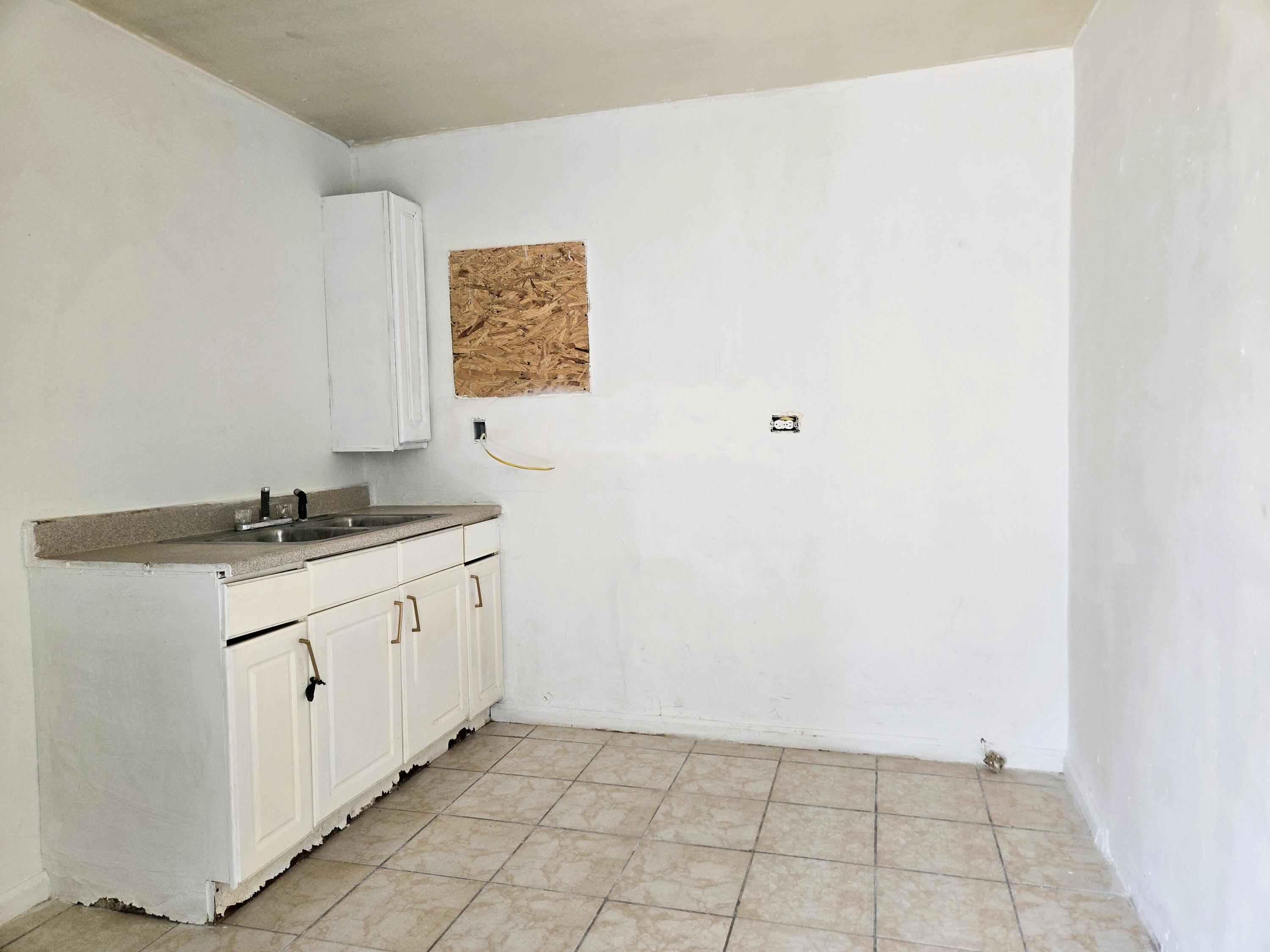 1423 2nd Street Coachella, CA 92236 - Photo 11 of 12 a bathroom with a granite countertop sink and a mirror
