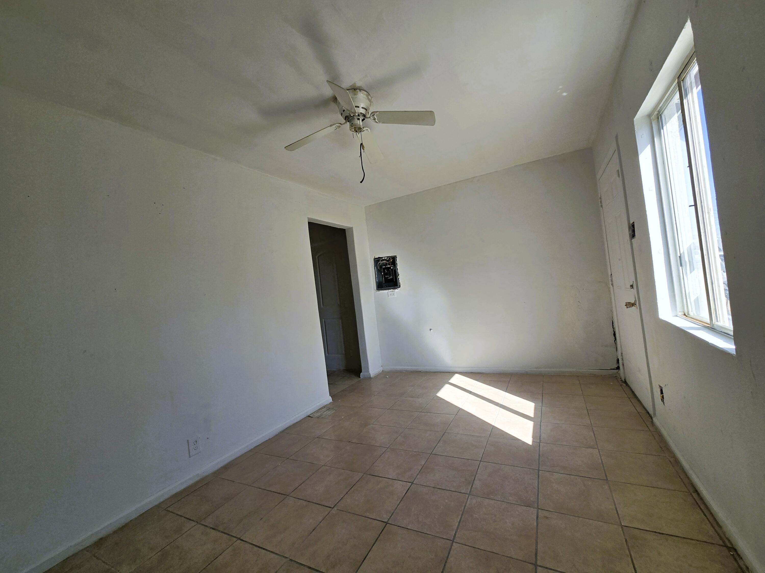 1423 2nd Street Coachella, CA 92236 - Photo 12 of 12 an empty room with chandelier fan and windows