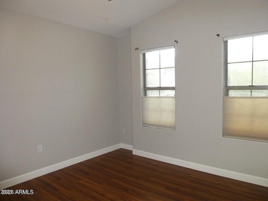 2727 North Price Road, Unit 28 Chandler, AZ 85224 - Photo 6 of 14 an empty room with wooden floor and windows