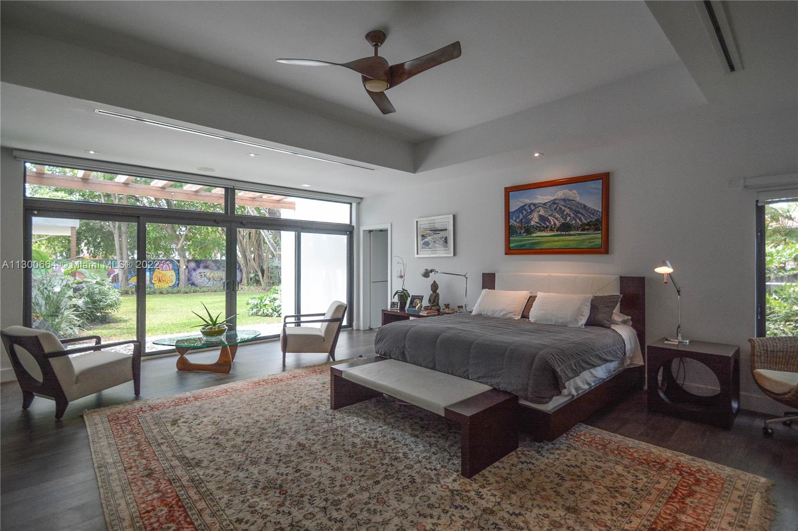 4560 Bay Point Road Miami, FL 33137 - Photo 15 of 40 a spacious bedroom with a large bed and a large window