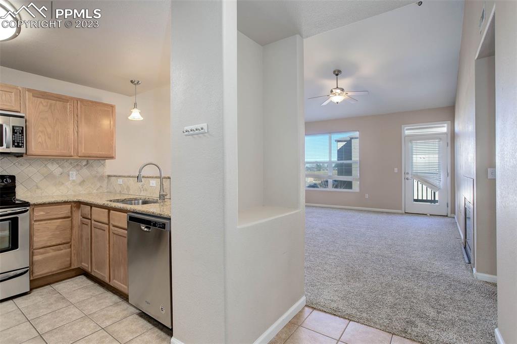605 Cougar Bluff Point, Unit 210 Colorado Springs, CO 80906 - Photo 17 of 33 a kitchen with a sink stove and cabinets