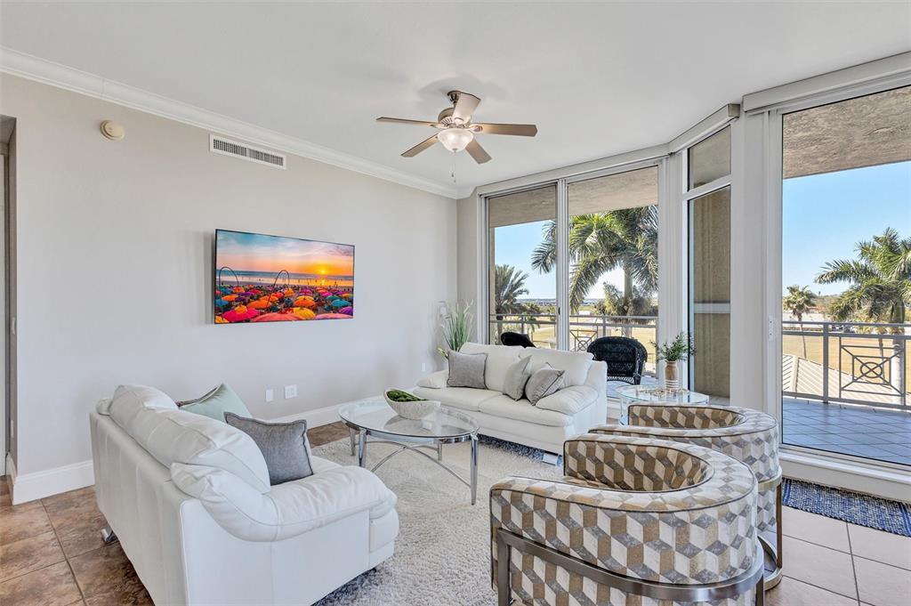 140 Riviera Dunes Way, Unit 206 Palmetto, FL 34221 - Photo 6 of 46 a living room with furniture and a large window