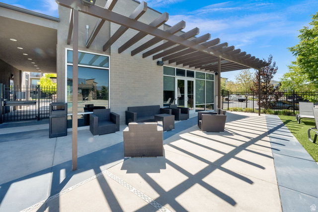 7713 Navarro View Court Midvale, UT 84047 - Photo 31 of 41 Outdoor patio with a slatted pergola, featuring concrete paving and an artificial turf area