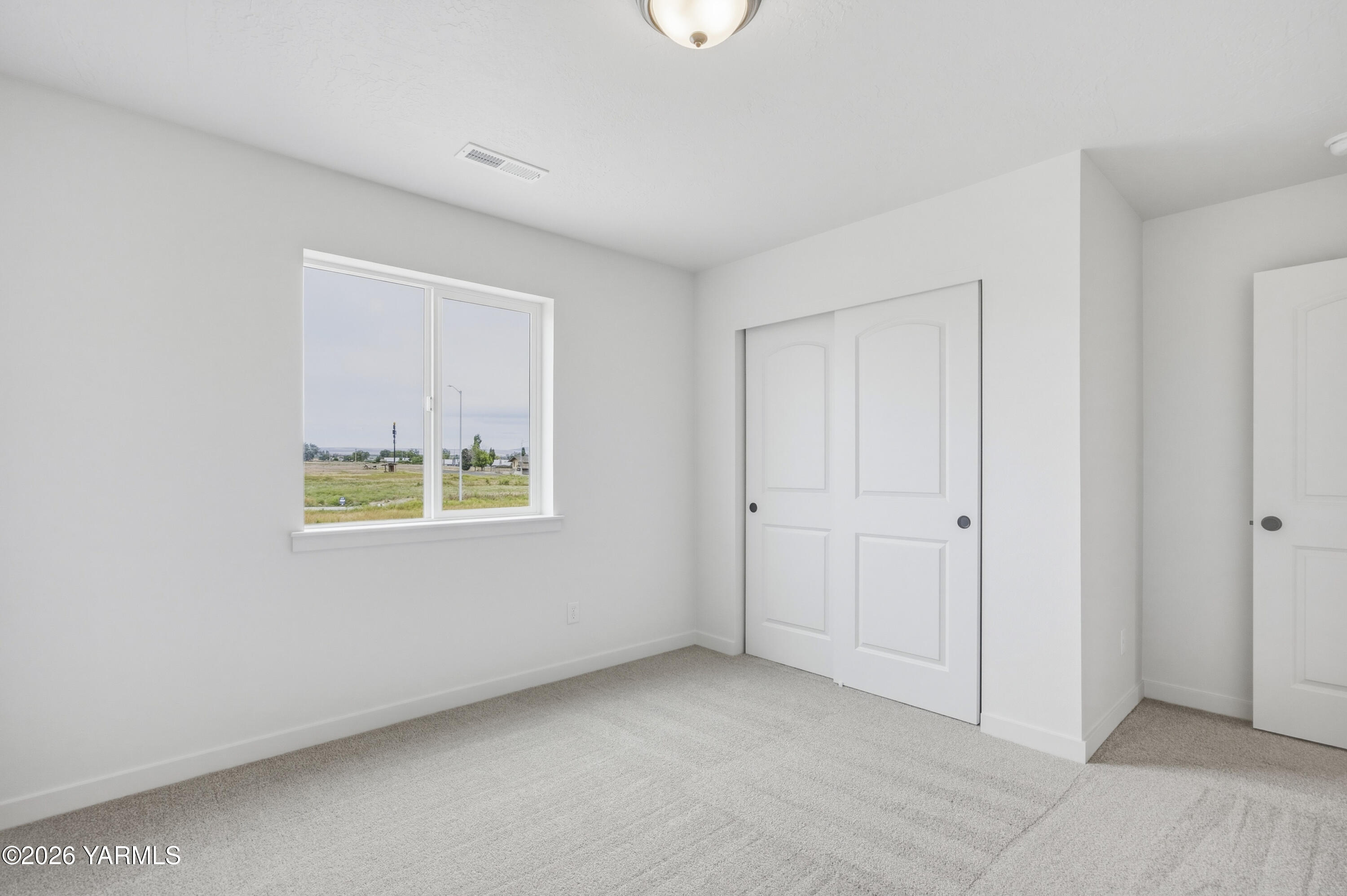 215 Packer Street Prosser, WA 99350 - Photo 18 of 45 a view of an empty room with a window