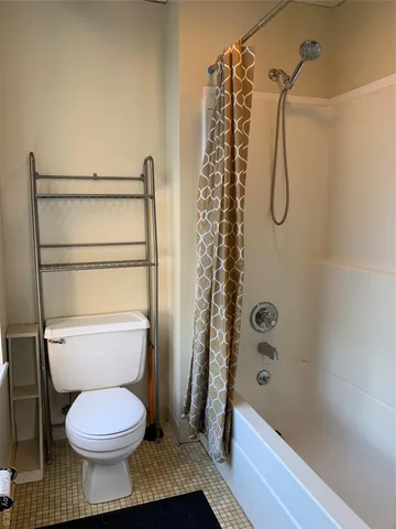 a bathroom with a toilet and a shower