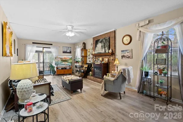 a living room with furniture a clock on wall and a window