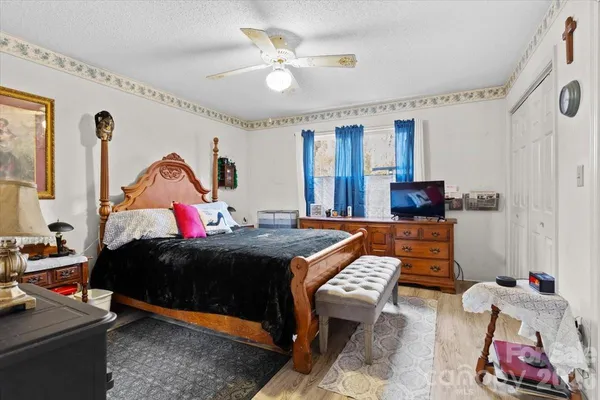 a bed room with a bed window and a chair