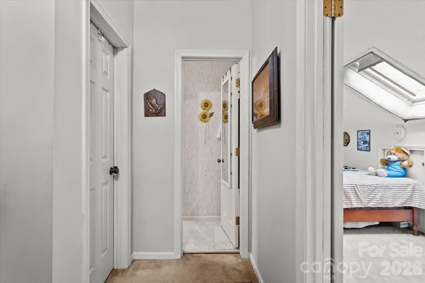 a view of room with walk in closet and bathroom