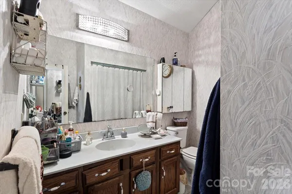 a bathroom with double vanity and a mirror