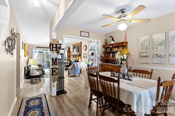 a view of a livingroom with furniture and a fan