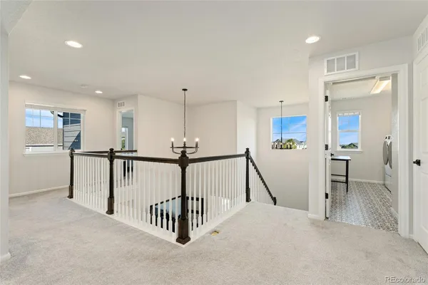 a view of a hallway with a living room and staircase