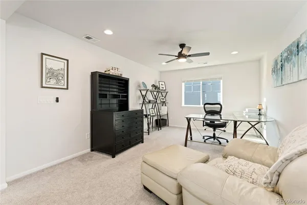 a living room with furniture a chandelier and a flat screen tv