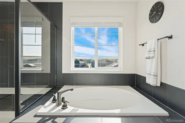 a bathroom with a tub and a window