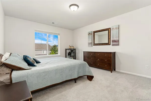 a bedroom with a bed and a couch