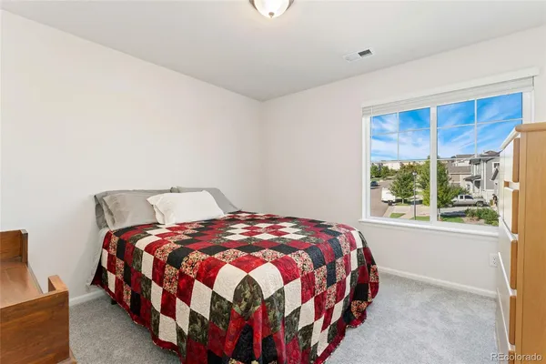 a bedroom with a bed lamp and window