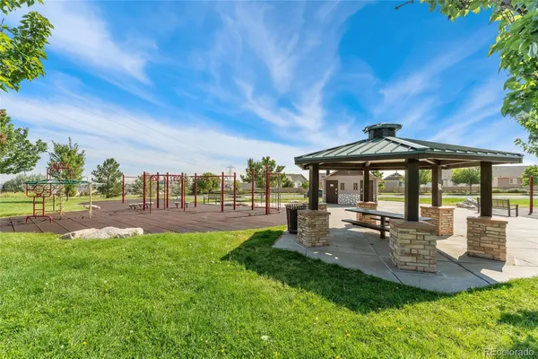 a view of a park with potted plants and wooden fence