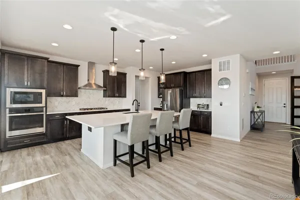 a large kitchen with lots of counter space and stainless steel appliances