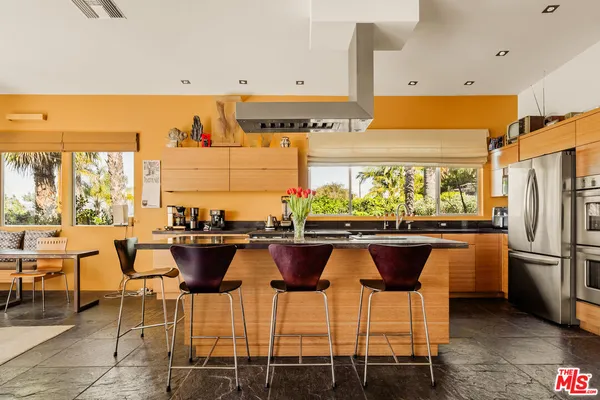 a kitchen with a table and chairs in it