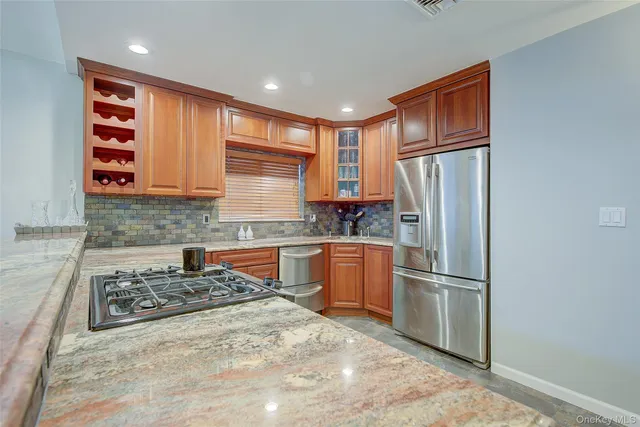 a kitchen with stainless steel appliances granite countertop a stove and a sink