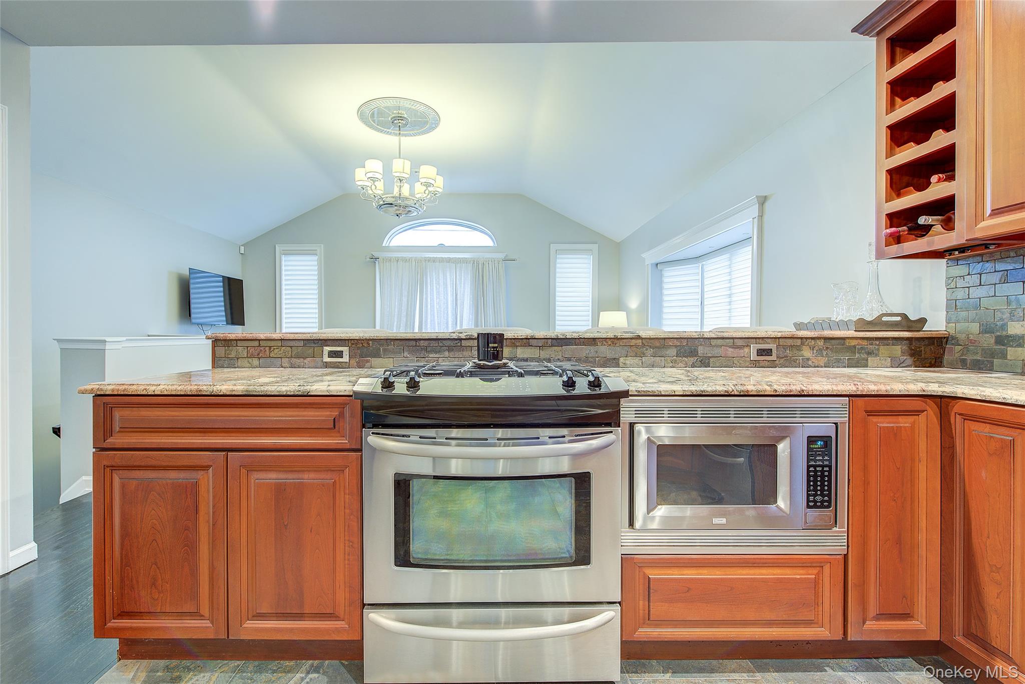 161 Beach 128th Street, Unit 1B Queens, NY 11694 - Photo 15 of 36 a kitchen with stainless steel appliances granite countertop a stove and a sink