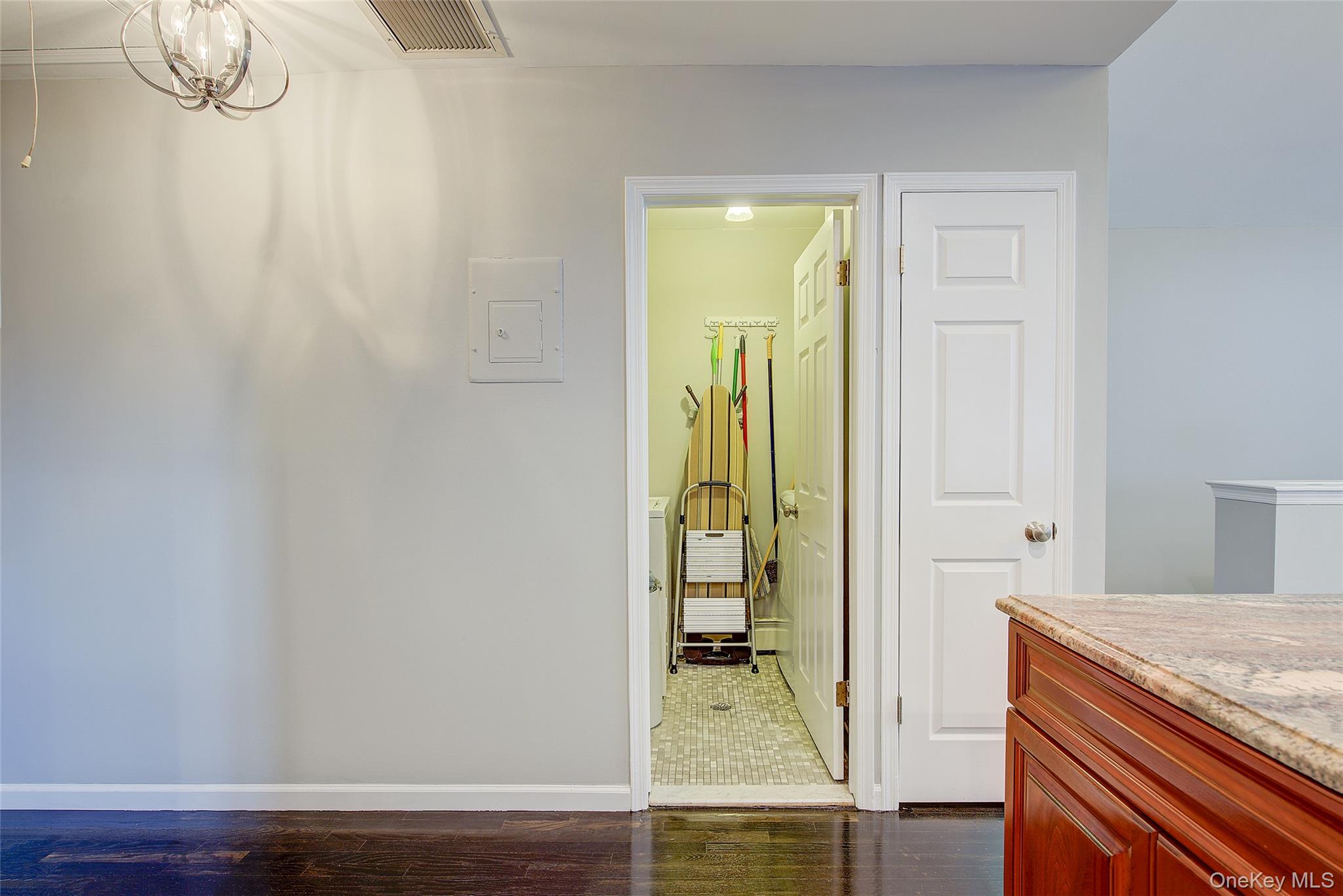 161 Beach 128th Street, Unit 1B Queens, NY 11694 - Photo 18 of 36 Bathroom featuring vanity, dark wood finished floors, and a chandelier